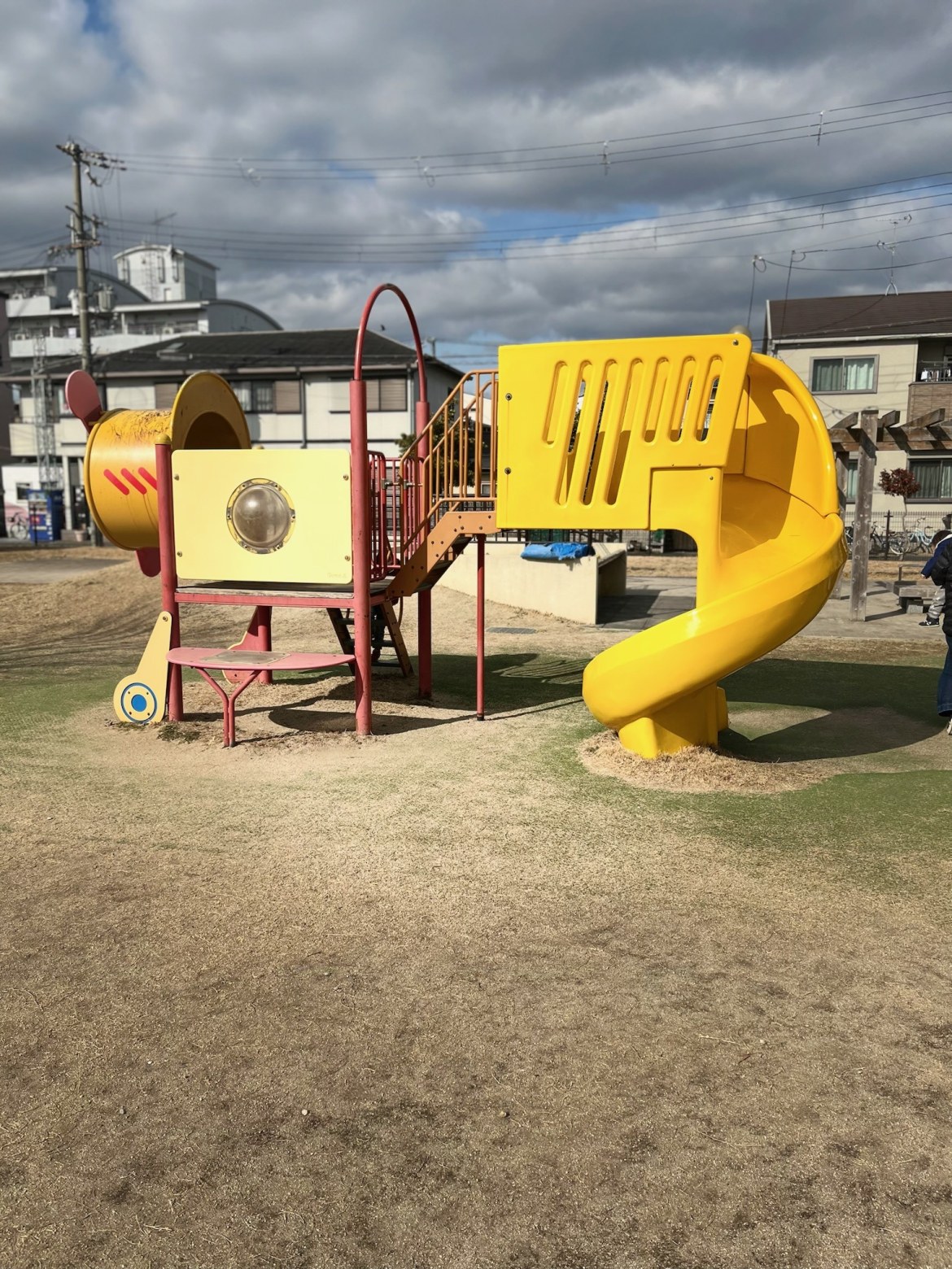 黄色いらせん滑り台のついた複合遊具