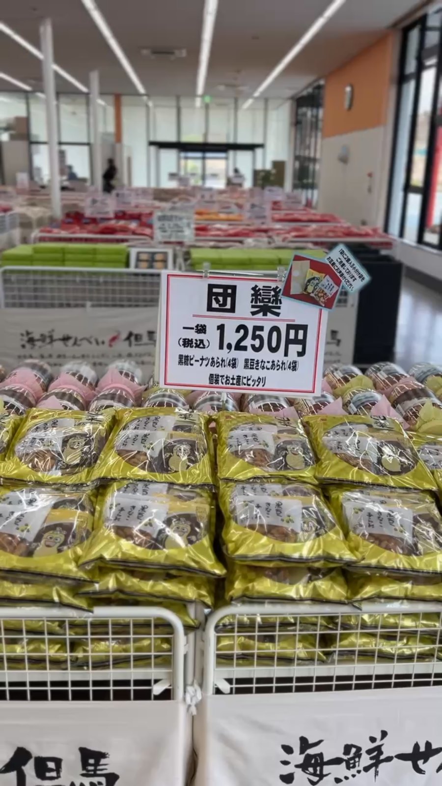 袋詰めのあられが山積みになった売り場